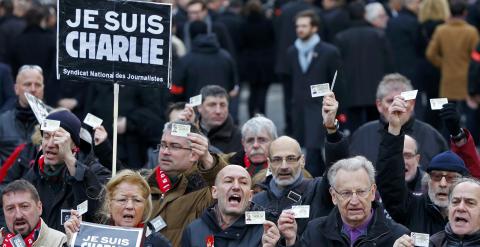 French journalists holding up their Press card take part in a hundreds of thousands of French citizens solidarity march (Marche Republicaine) in the streets of Paris January 11, 2015. French citizens will be joined by dozens of foreign leaders, among them