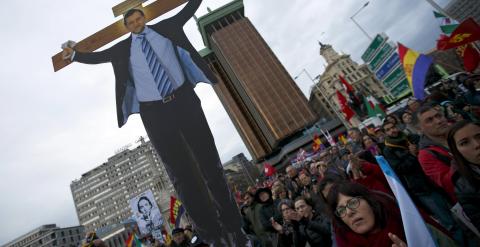 Un manifestante sostiene una imagen del presidente del Gobierno, Mariano Rajoy,  crucificado, durante la concentración de las Marchas de la Dignidad en la madrileña Plaza de Colón. REUTERS/Sergio Perez