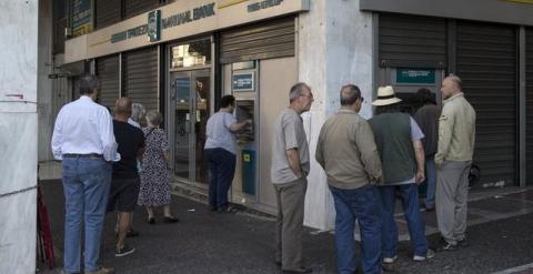 Tras la convocatoria del referéndum sobre las medidas de las instituciones, la fuga de capitales se ha agudizado en Grecia. En la imagen, colas en un cajero de Atenas. Marko Djurica (EFE)