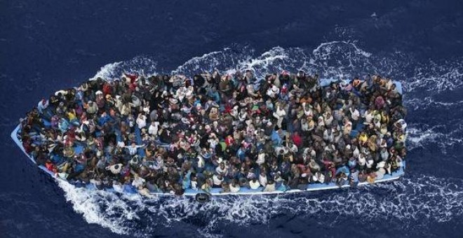 Guardacostas italianos en aguas libias rescatando a uno de los muchos barcos llenos de inmigrantes que intentan cruzar con la llegada del buen tiempo. EFE