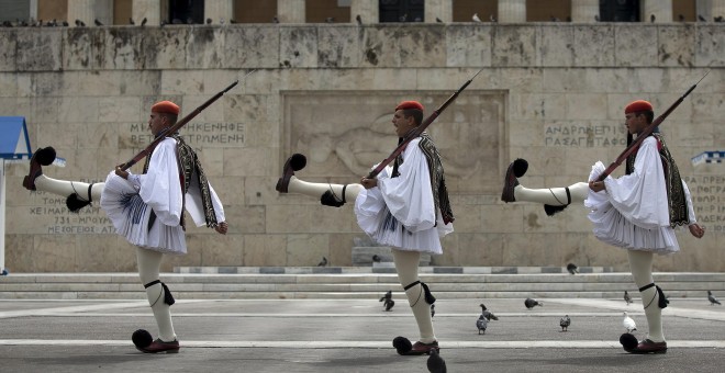 Greek Presidential guards take part in a ceremonial change of guards at the Monument of the Unknown Soldier in front of the Parliament building in Athens.- REUTERS.