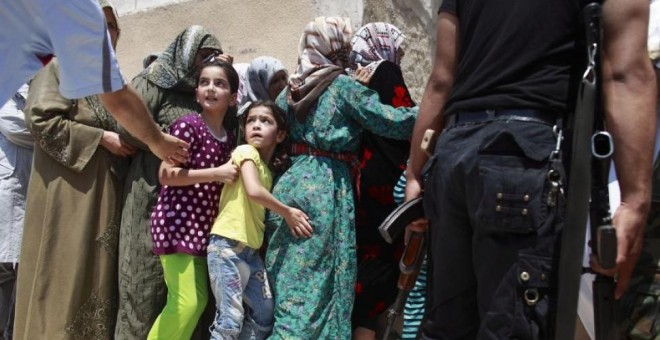 Mujeres y niás en Siria./ REUTERS