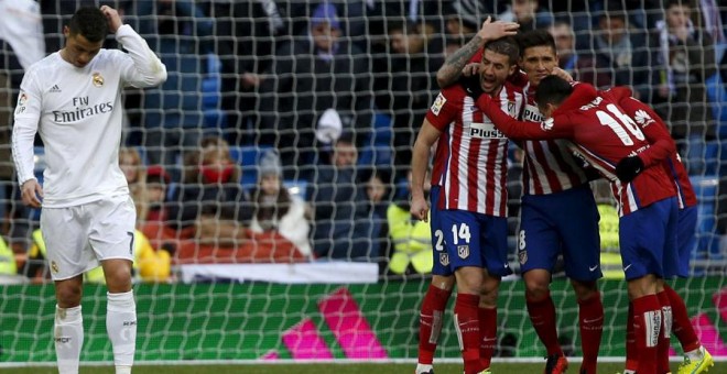 Los jugadores del Atlético celebran la victoria contra el Madrid con Cristiano al lado cabizbajo. REUTERS/Sergio Pérez