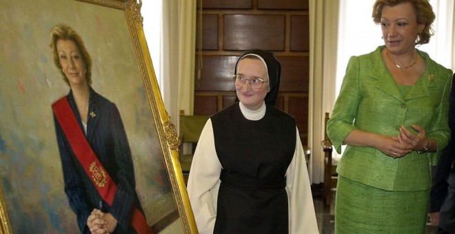 La monja pintora del convento zaragozano de Santa Lucía, Isabel Guerra, muestra un retrato de la expresidenta del Gobierno de Aragón, Luisa Fernanda Rudi. EFE