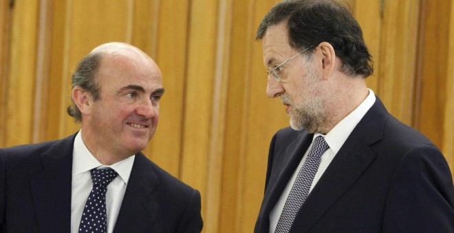 Luis de Guindos con Mariano Rajoy. EFE