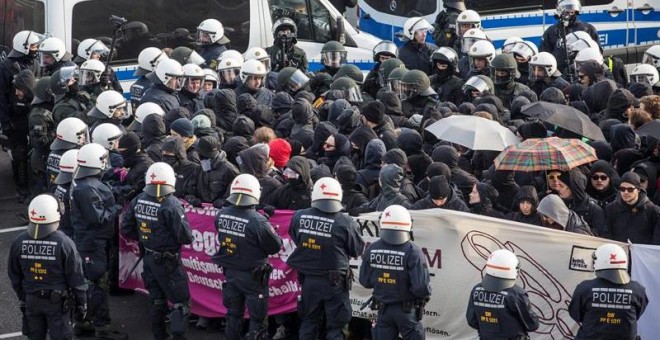 La policía rodea al grupo de manifestantes que tratan de bloquea el acceso al centro de exhibiciones donde tiene lugar el congreso de Alternativa para Alemania (AfD). EFE/EPA/CHRISTOPH SCHMIDT