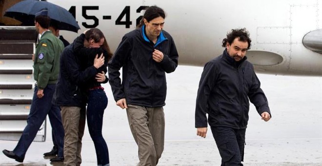 Ángel Sastre, José Manuel López y Antonio Pampliega (abrazando a un familiar) a su llegada a la Base äerea de Torrejón de Ardoz, en Madrid. - EFE
