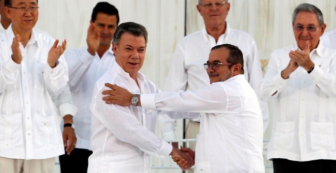 El presidente de Colombia, Juan Manuel Santos, y el líder de las FARC, Rodrigo Londoño, 'Timochenko', estrechan sus manos tras la firma del acuerdo de paz en la ciudad de Cartagena de Indias, el pasado 26 de septiembre. REUTERS/John Vizcaino