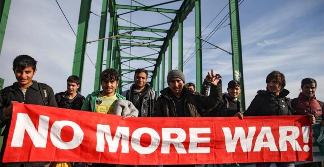 Refugiados y migrantes cruzan el puente Old Sava en dirección a la frontera con Croacia al inicio de la marcha. REUTERS/Marko Djurica