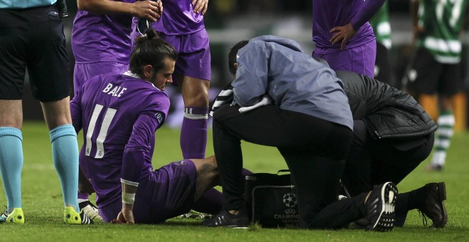 Gareth Bale es atendido por los médicos del Real Madrid tras lesionarse el martes en Lisboa. /REUTERS