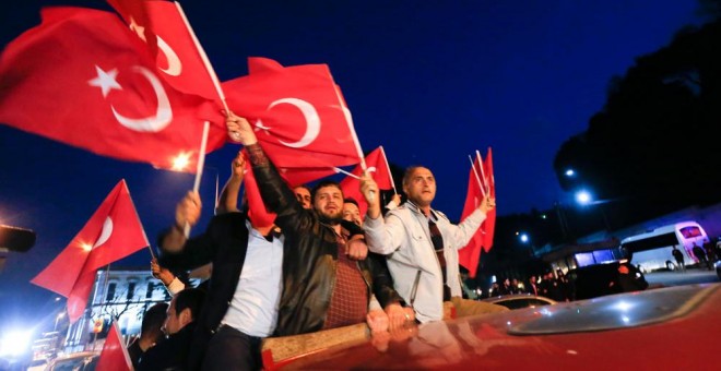 Simpatizantes de Erdogan ondean la bandera turca para celebrar la victoria del 'sí' en el referéndum esta tarde en Estambul. REUTERS