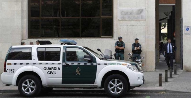 Agentes de la Guardia Civil ante la sede de Canal de Isabel II. | EMILIO NARANJO (EFE)
