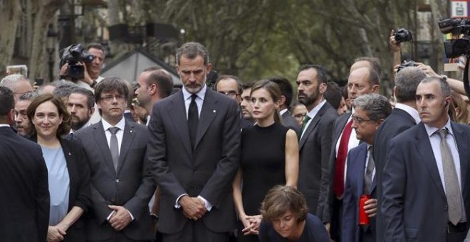 Los reyes, el presidente de la Generalitat, Carles Puigdemont; la vicepresidenta del Gobierno, Soraya Saénz de Santamaría  y la alcaldesa de Barcelona, Ada Colau, entre otros, en La Rambla de Barcelona durante un homenaje a las víctimas de los atentados