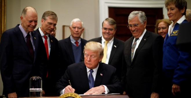 Donald Trump en la firma de la directiva que ordena a la NASA iniciar un programa de exploración espacial para enviar astronautas a la Luna y eventualmente a Marte. REUTERS/Carlos Barria