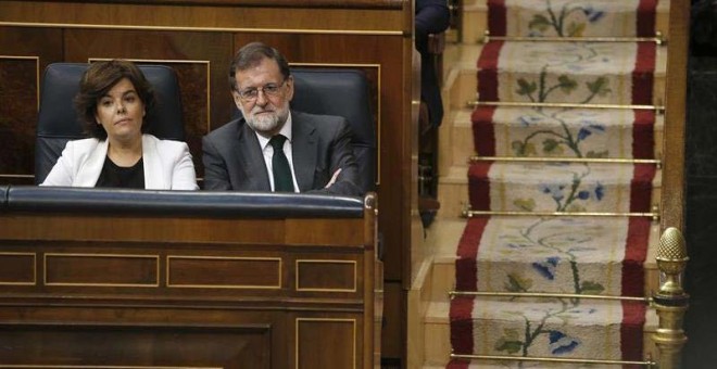 La vicepresidenta del Gobierno, Soraya Sáenz de Santamaría, y el presidente Mariano Rajoy siguen la votación. (EFE)