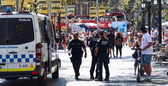 21/08/2019.- Agentes de la Guardia Urbana en las inmediaciones de la Rambla, en el distrito barcelonés de Ciutat Vella, donde los vecinos conviven desde hace décadas con la inseguridad a la vuelta de la esquina. Están tan cansados como acostumbrados, dice