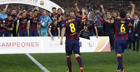 Xavi e Iniesta llevan la Copa del Rey al resto de sus compañeros. /EFE