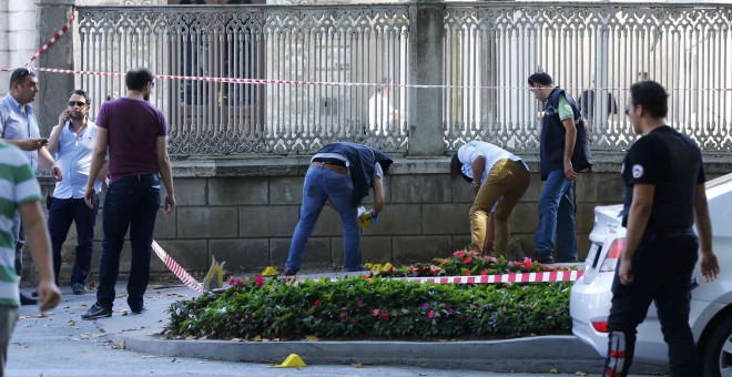Dos policías turcos examinan la zona cerca del Palacio Dolmabahçe, en estambul, tras el tiroteo protagonizado por dos personas. REUTERS/Murad Sezer