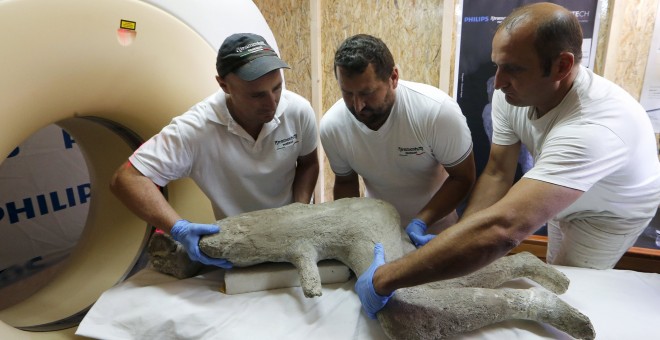 Los investigadores preparan para introducir en escáner el molde de yeso de un niño romano de la antigua ciudad romana de Pompeya. REUTERS / Ciro De Luca