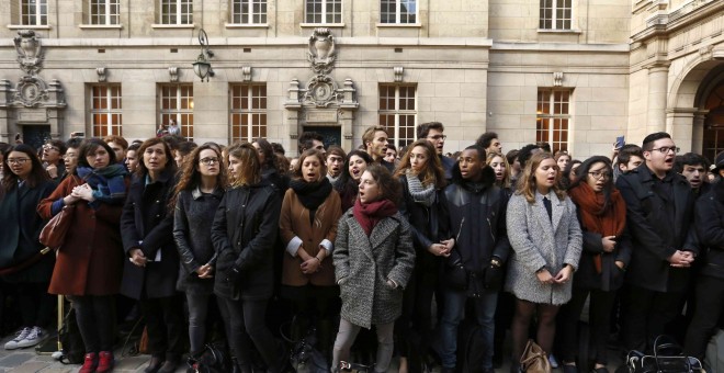 Un grupo de estudiantes canta el himno francés, 'La Marsellesa', tras el minuto de silencio guardado en la Universidad de la Sorbona por las víctimas de los atentados yihadistas en París. REUTERS/Guillaume Horcajuelo