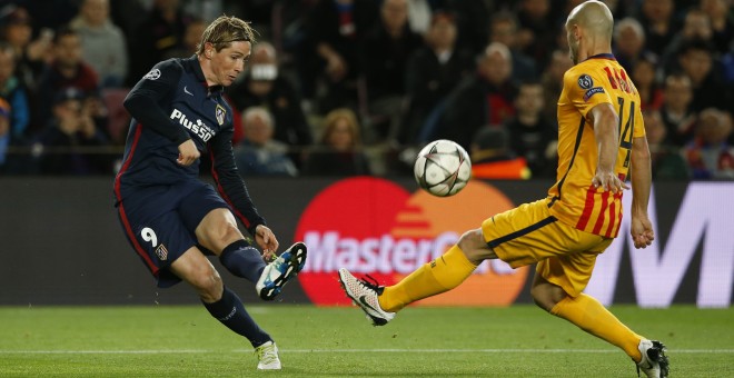 Fernando Torres y Javier Mascherano disputan el balón durante el Barcelona-Atlético de Madrid de Champions. - REUTERS