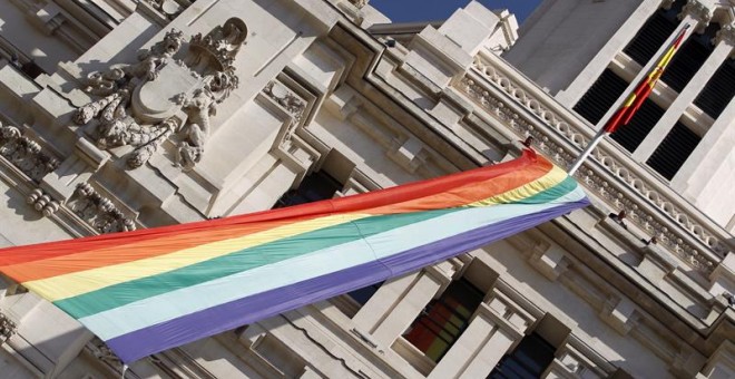 Vista de la bandera arcoíris desplegada en la fachada del Ayuntamiento de Madrid con motivo del comienzo de la semana del orgullo gay. EFE/Javier Lizón