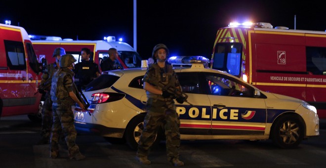 French soldiers and rescue forces are seen at the scene whare at least 30 people were killed in Nice, France, when a truck ran into a crowd celebrating the Bastille Day national holiday July 14, 2016. REUTERS/Eric Gaillard