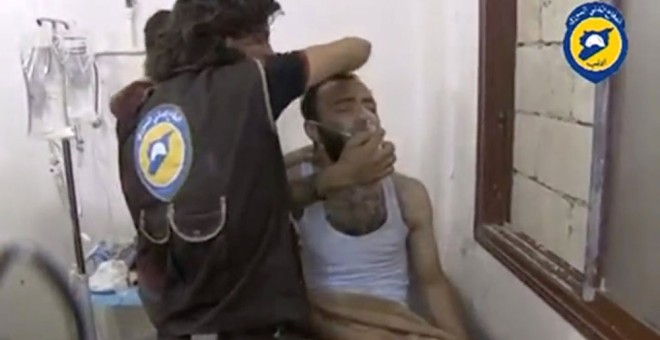 Miembros dMiembros de la Defensa Civil Siria atienden a la población con máscaras tras el supuesto ataque químico. REUTERS