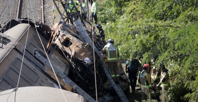 Los bomberos trabajan en el lugar del accidente en el que ha descarrilado un tren en O Porriño, Galicia. REUTERS/Miguel Vidal