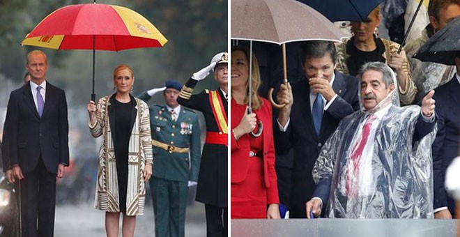 Cifuentes y Revilla se resguardan de la lluvia durante el desfile.- EFE