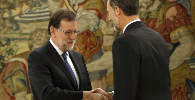 El rey Felipe VI saluda al reelegido presidente del Gobierno, Mariano Rajoy, momentos antes del acto de jura del cargo de jefe del Ejecutivo en el Palacio de La Zarzuela. EFE/Chema Moya