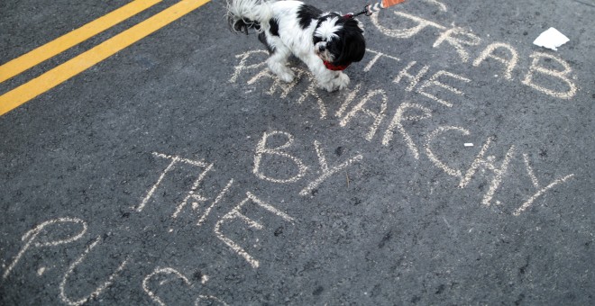 chalk slogan is seen on the road at the International Women's Day 'A Day Without a Woman' anti-Trump protest in Los Angeles, California, U.S., March 8, 2017. REUTERS/Lucy Nicholson