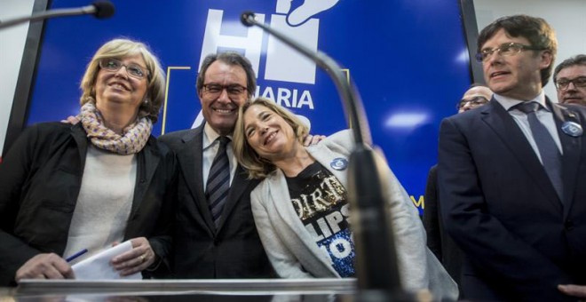 El expresidente Artur Mas flanqueado por la exvicepresidenta Joana Ortega, a la derecha, y la exconsellera de Enseñanza Irene Rigau, a la izquierda de la imagen. Al lado, el president Puigdemont. | QUIQUE GARCÍA (EFE)