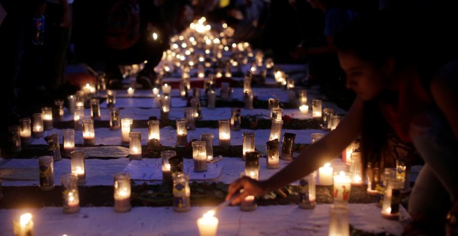 Candles are lit during a protest to demand justice for the victims of a fire at the Virgen de Asuncion children's shelter, in front of the National Palace in Guatemala City, Guatemala, March 11, 2017. REUTERS/Saul Martinez