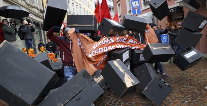 Un manifestante rompe un muro simbólico durante la marcha en protesta contra el G-20, durante su reunión en la ciudad alemana de Baden Baden. REUTERS/Kai Pfaffenbach