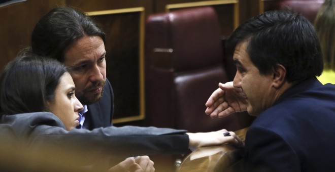 El diputado del PP y secretario de Estado de Relaciones con las Cortes, José Luis Ayllón, conversa con el el líder de Podemos, Pablo Iglesias, y la portavoz del partido, Irene Montero, durante el debate de las enmiendas a la totalidad de los presupuestos