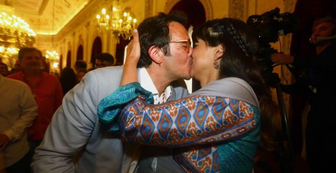 El líder de Adelante Cádiz José María González, 'Kichi', tras ser investido de nuevo alcalde de la ciudad recibe la felicitación de su pareja y madre de su hija, la líder de Podemos Andalucía, Teresa Rodríguez, en el Ayuntamiento tras el pleno en el que