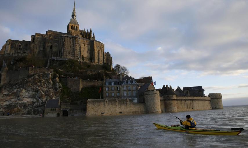 Un hombre se acerca hasta el Mont Saint-Michel sobre una piragua.. REUTERS/Pascal Rossignol