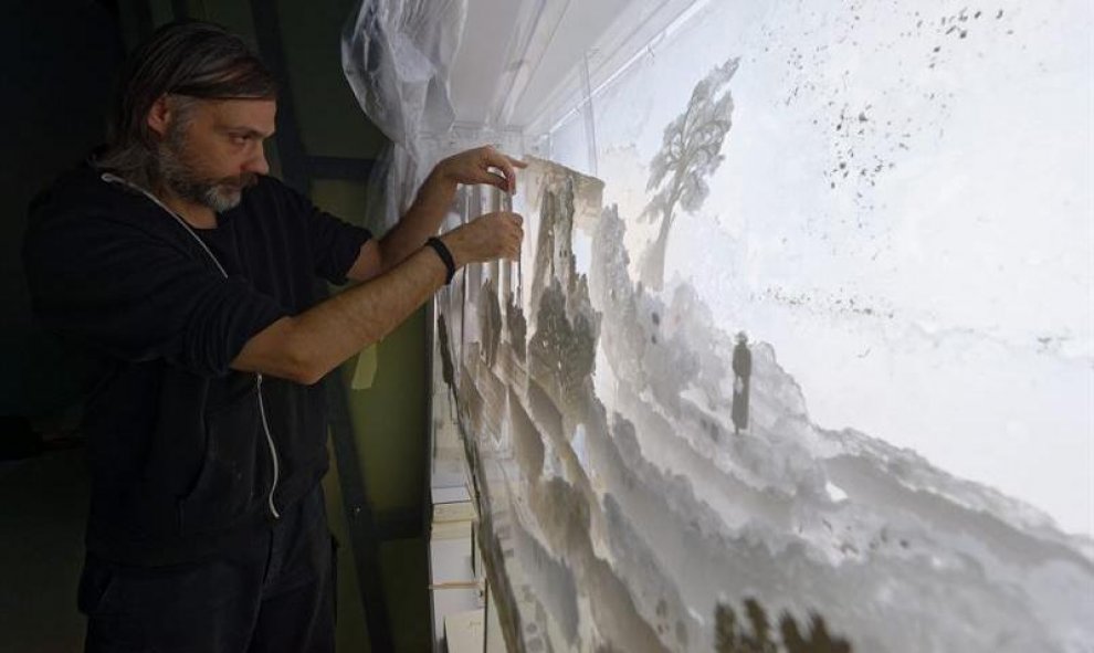 El artista Alexej Tchernyi trabaja en una de sus obras durante la presentación de Grimmwelt, un nuevo museo dedicado a los hermanos Grimm, en Kassel (Alemania). EFE/Swen Pfoertner