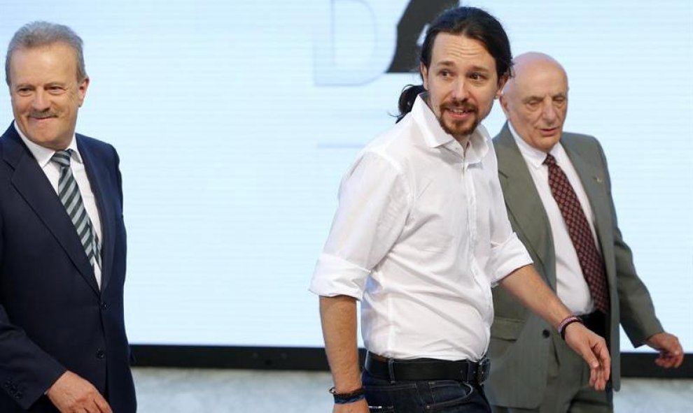 El candidato por Unidos Podemos a la presidencia del Gobierno, Pablo Iglesias (c), acompañado por el presidente de la Academia de la Televisión, Manuel Campo Vidal (i), y el realizador Fernando Navarrete (d), a su llegada al Palacio Municipal de Congresos