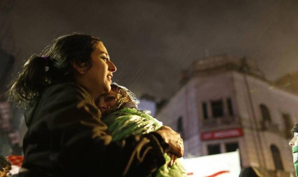 Dos jóvenes partidarias del aborto legal se abrazan y lloran bajo la lluvia frente al Congreso argentino - NATACHA PISARENKO/EFE