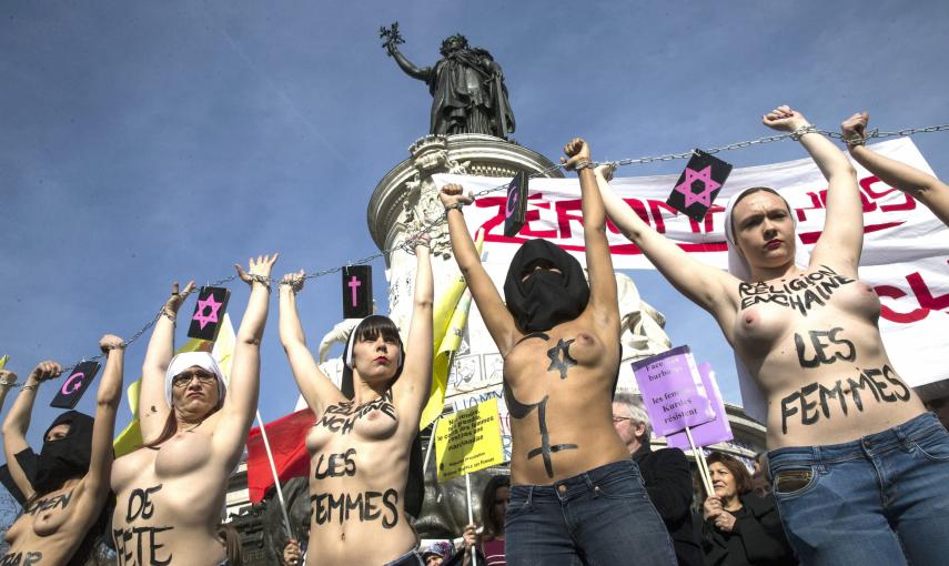 Varias activistas de Femen se encadenaron juntas, en el marco de una manifestación organizada desde la plaza de la República con motivo del Día de la Mujer, con cadenas de las que colgaban símbolos de diferentes religiones, como la cristiana, la judía o l