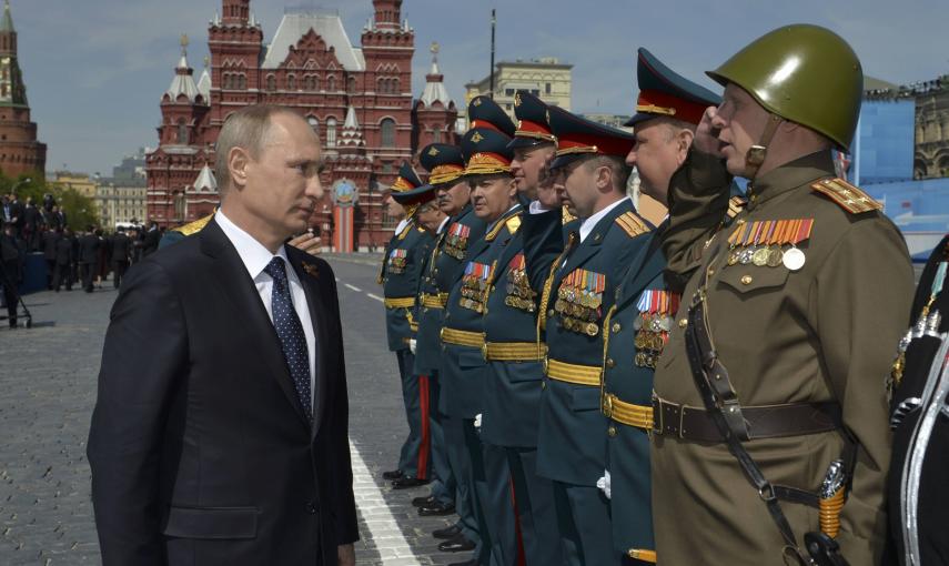 Russia's President Vladimir Putin (L) greets the commanders of units, participants of the Victory Day parade at Red Square in Moscow, Russia. REUTERS/Host Photo Agency/RIA Novosti