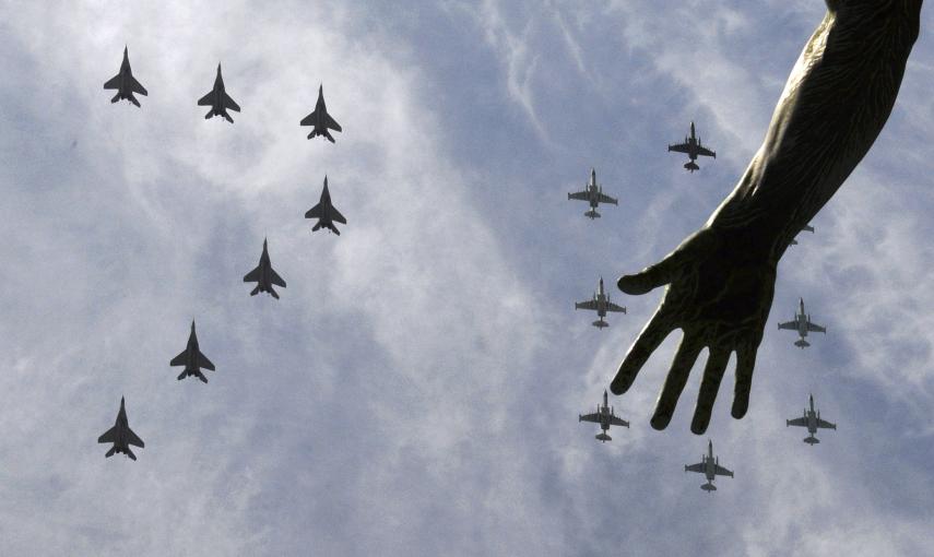 MiG-29 and Su-25 military jets fly in formation above Red Square during the Victory Day parade in Moscow. REUTERS/Host Photo Agency/RIA Novosti