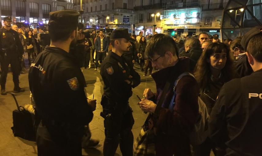 Agentes de la Policía Nacional identifican a uno de los asistentes a la concentración convocada por el movimiento 15-M para emitir un "grito silencioso" justo al comienzo de la jornada de reflexión. Foto: KIKE ÁLVAREZ