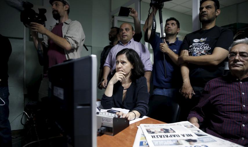 An employee of Greek state broadcaster ERT looks at monitor screens at the control room during the first broadcast of the station after its reopening./ REUTERS/Alkis Konstantinidis