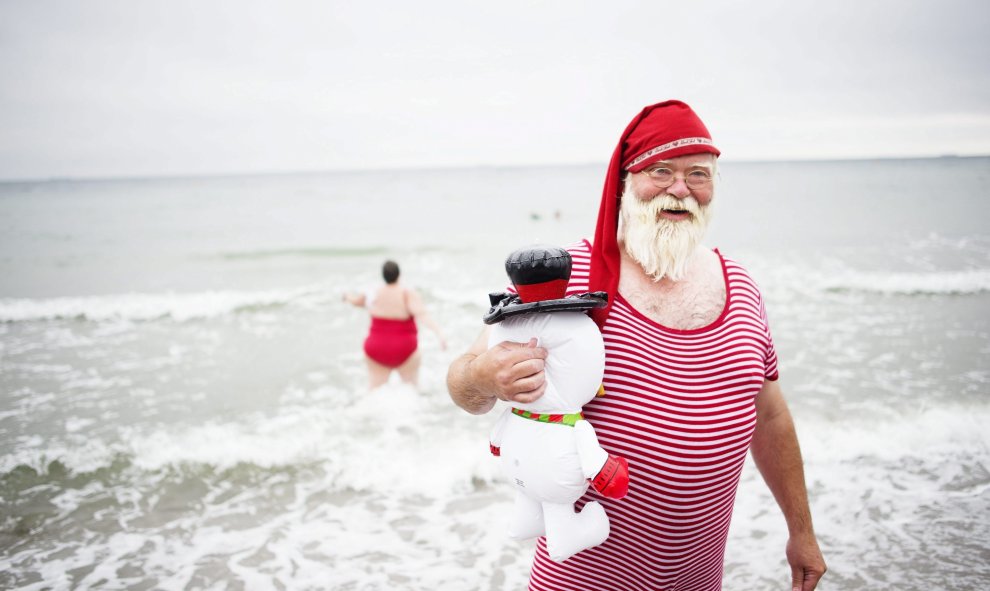 Un hombre ataviado como Papá Noel participa en la celebración del tradicional baño del Congreso Mundial de Papá Noel en la playa de Bellevue al norte de Copenhague (Dinamarca) hoy, 21 de julio de 2015. EFE/Erik Refner
