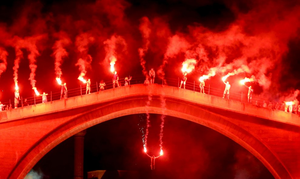 Un hombre salta desde el Puente Viejo de Mostar. Las competiciones de buceo han sido tradicionalmente celebradas aquí todos los años desde que el puente fue construido hace 449 años. REUTERS / Dado Ruvi