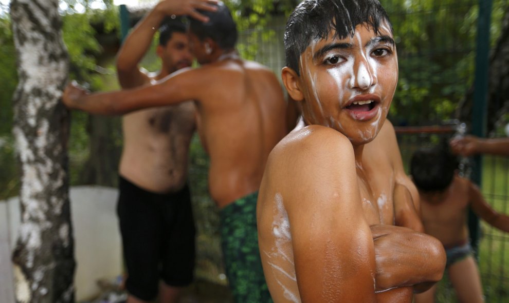 Un joven de Afganistán se lava en un refugio improvisado fuera de una fábrica de ladrillos en Subótica, Serbia 27 de julio de 2015. REUTERS / Laszlo Balogh