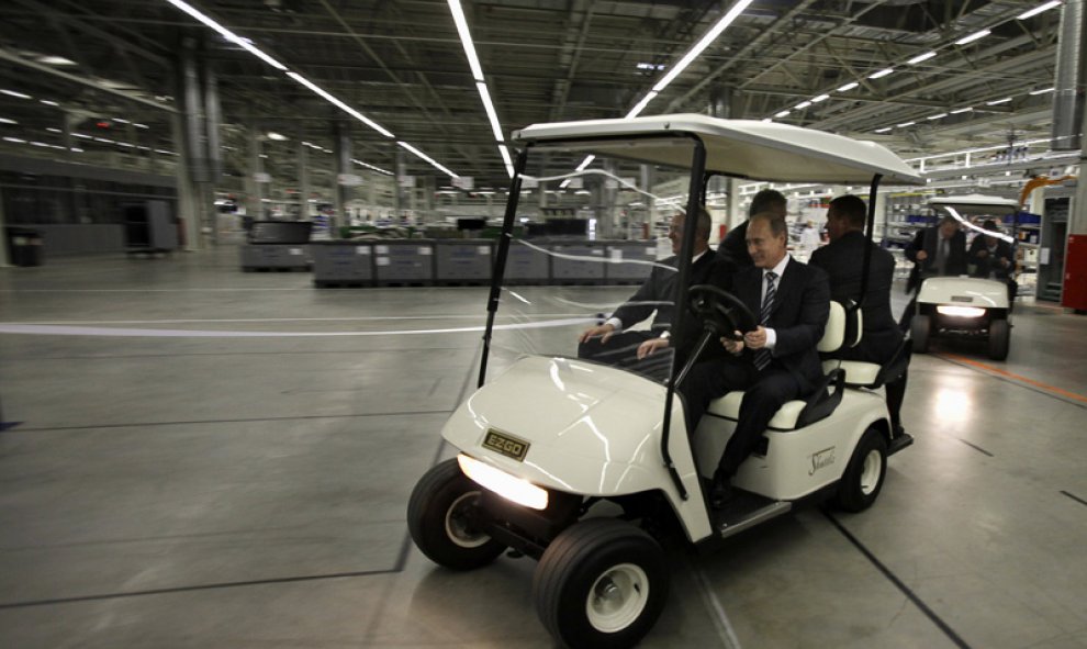 Putin conduce en un carrito con el CEO de Volkswagen, Martin Winterkorn durante la inauguración de una planta de Volkswagen en Kaluga, el 20 de octubre de 2009.- AFP PHOTO / POOL / ALEXANDER ZEMLIANICHENKO